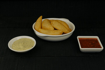 Delicious traditional Colombian empanadas with spicy sauce