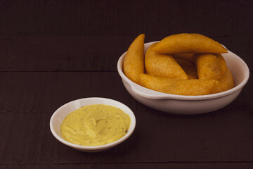 Colombian empanada with spicy sauce 