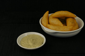 Colombian empanada with spicy sauce 