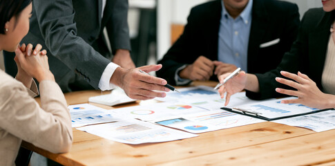 diverse coworkers working together in boardroom, brainstorming, discussing and analyzing and planning business strategy. © NAMPIX