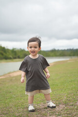 Close up of baby boy standing and smile with out door, Nature park with baby boy.