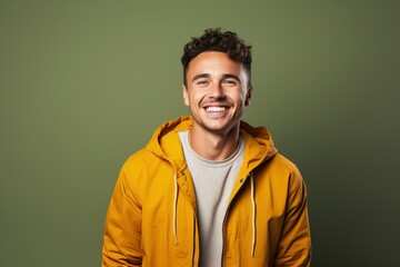 Fototapeta premium A man in a yellow jacket is smiling and looking at the camera
