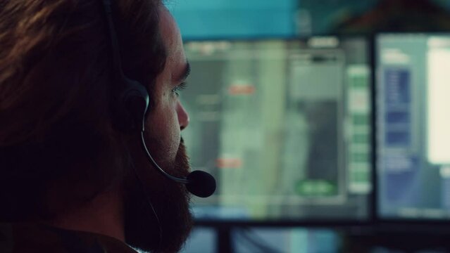 Commander communicating with allied forces and transmitting data from surveillance footage, coordinating joint operations and strategies to accomplish mission. Satellite radar operator. Camera A.