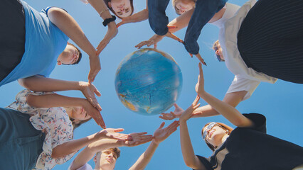 Students make a circle around the globe of the world. The concept of world peace. © Довидович Михаил