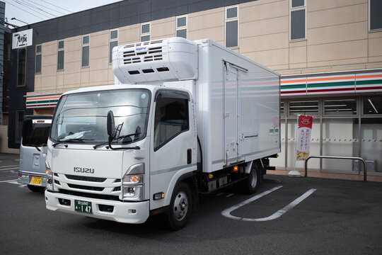 Shizuoka, Japan - November 12 2023 : A 7-11 delivery truck parking outside a 7-11 convenience store located by the roadside in the town of Fuji, Shizuoka.
