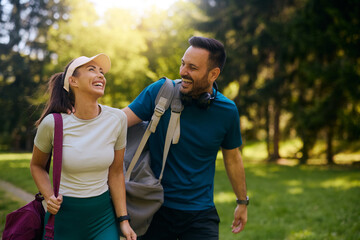 Happy athletic couple having fun after sports training in park.