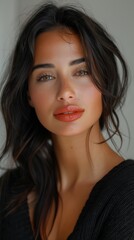 Fototapeta premium portrait of a fashion model looking at camera with eye lashes lipstick full makeup volume of hair straight face looking at camera smiling