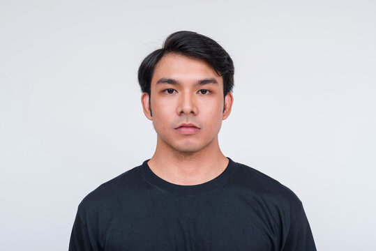 Handsome asian man in a black shirt isolated on white background