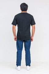 Obraz premium Handsome Asian man in black T-shirt standing, isolated on white background