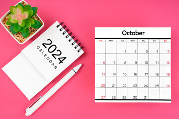 White calendar for October 2024 and pen on pink color background. - Powered by Adobe