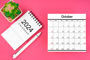 White calendar for October 2024 and pen on pink color background.