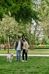 A bearded gay couple in casual attire enjoys a sunny afternoon in the park with their labrador retriever.