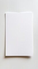 Blank white paper sign on a wooden surface with clip