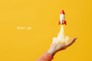 A rocket on a man's arm. Rapid business development, startup