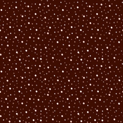Seamless retro polka dot pattern. Small white, beige polka dots on a brown background.