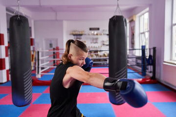 Young boxer doing shadow boxing in a gym
