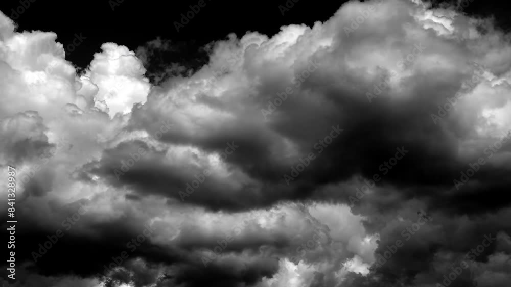 Wall mural time-lapse of separate white clouds on a black background have real clouds.