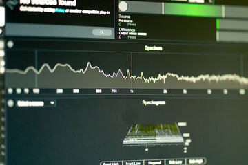 close up in a dark recording studio monitor with a sound track, cleaning, mixing and processing...