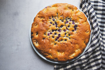 Delicious freshly baked homemade blueberry pie on gray background. Sweet food.