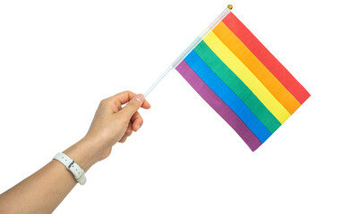 Someone hand holding a rainbow flag during a PRIDE month. The rainbow flag is a symbol of lesbian, gay, bisexual, transgender and queer pride commonly used at LGBTQIA+ rights events worldwide.