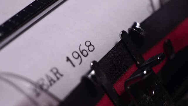 Year 1968, Typing in Vintage Typewriter on Blank White Paper, Close Up