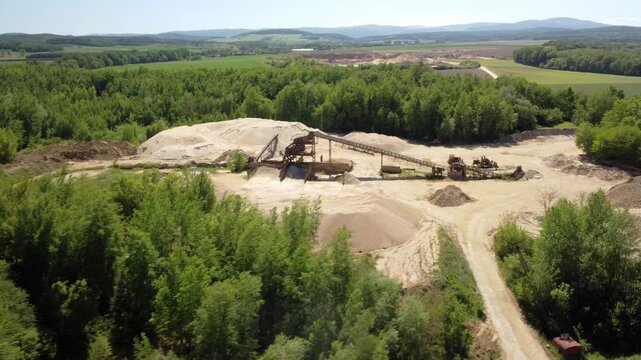 An Old Sand Mine Nestled in the Heart of a Lush Green Landscape Near the Town of Prudnik, Poland - Aerial Drone Shot