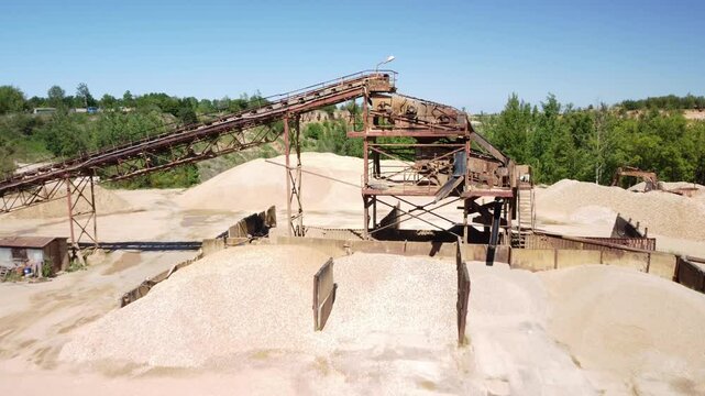 Piles of Sand and a Conveyor Belt at an Old Sand Quarry Close to the Town of Prudnik, Poland - Aerial Pullback Shot