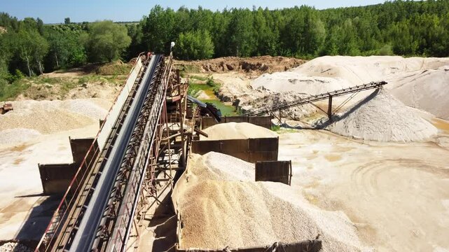 Mounds of Sand and a Conveyor Belt at an Old Sand Quarry Near Prudnik, Poland - Drone Flying Forward