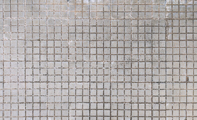 Top view of street pavement of small grey square concrete tiles texture or background. Current...
