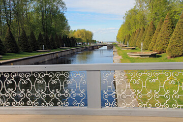 Russia, Saint-Petersburg. An ancient bridge over a canal in Peterhof on a spring day.