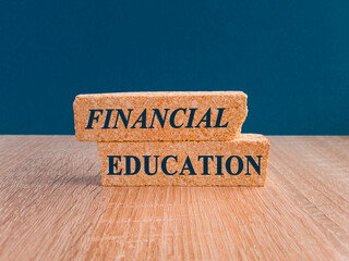 Concept words Financial education on beautiful brick block. Beautiful dark blue background. Wooden...