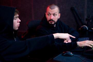 in the recording room dark With neon-lit studio, a sound recorder teaches his junior assistant how...