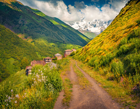 Exciting summer view of the Gaucasus mountains. Amazing morning landscape of the Khalde village with old country road. Outdoor scene of Upper Svaneti,  Georgia. Beauty of nature concept background.