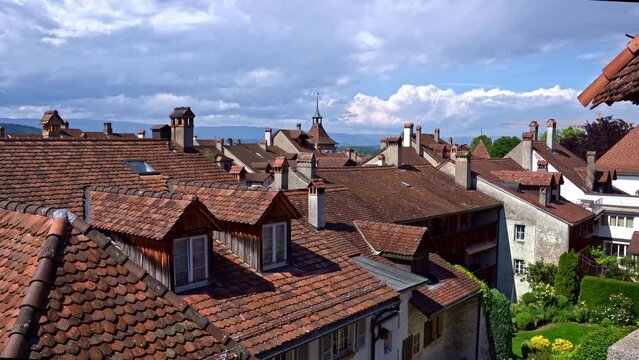 Panning of rooftops of medieval old town of Swiss City of Murten Morat on a cloudy spring day. Movie shot June 5th, 2024, Murten Morat, Switzerland.