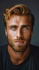Obraz premium Close-up portrait of a young man with a beard and striking blue eyes