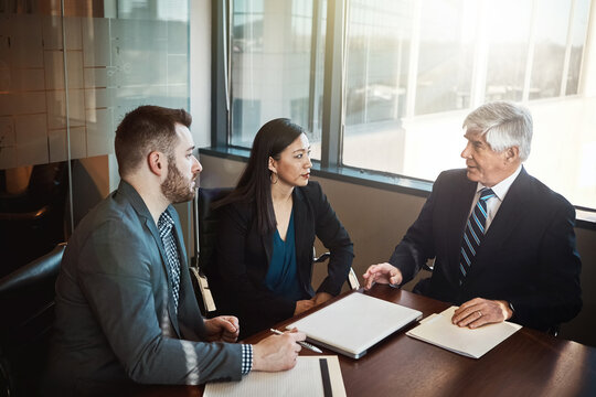 Men, woman and lawyer with documents in boardroom for discussion, negotiation and legal compliance. People, business owner and attorney with paperwork, laptop and listen to advice for company growth