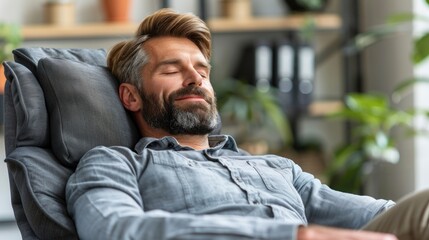A man relaxes in a comfortable reclining chair, eyes closed, enjoying a moment of peace and tranquility