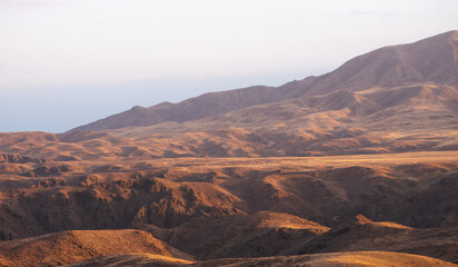 Autumn landscape of vast plains in China. Breathtaking, amazing, endless desert mountain landscapes bordering the Gobi Desert.