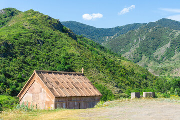 Saint Giorgi church of Okhera village. Stone roof and walls. Mountains around