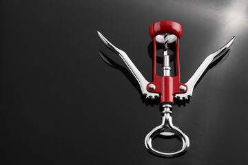 One wing corkscrew on grey table, above view. Space for text