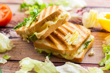 fried toasts with filling, salad leaves, tomatoes