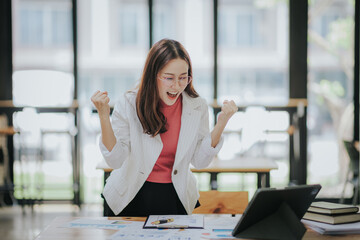 Attractive Asian businesswoman working at modern office with balance sheet documents. Accounting