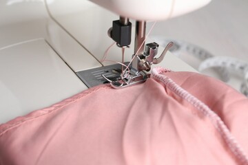 Sewing machine with color fabric on table, closeup