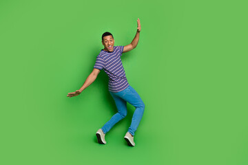 Photo of funny positive man wear striped stylish outfit have fun isolated on green color background