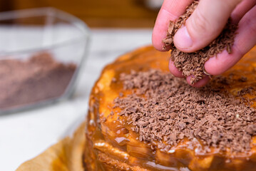 Preparing and baking a homemade sponge biscuit cake. Sprinkling the cake with chocolate chips.