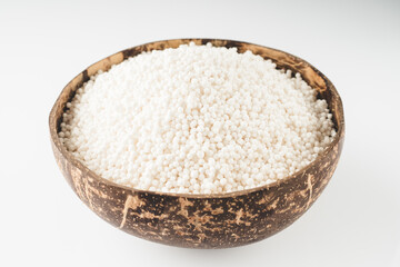 White Sago Pearls in Wooden Bowl Also Know as Sabudana, Tapioca Pearl or Sago Seeds isolated on White Background