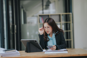 Asian businesswoman who is suffering from headache and stress due to overwork