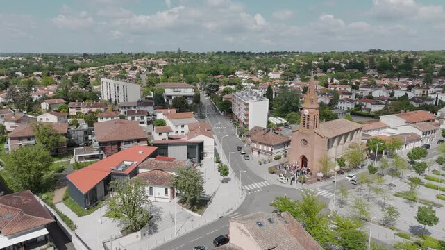 Aerial view of the Church of St. Joseph and the surrounding village area in Balma, Toulouse, France, on a sunny day