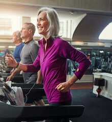 Fitness, smile and senior woman on treadmill in gym for health, wellness and body exercise....