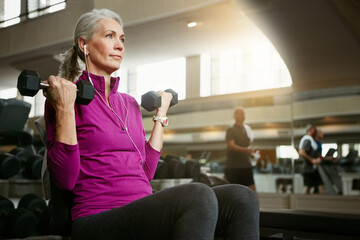 Dumbbell, gym and music with mature woman on bench for fitness, physical training or workout....
